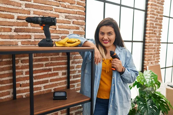 Young Beautiful Size Woman Smiling Confident Repairing Shelving New Home — Foto Stock