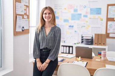 Young blonde woman business worker smiling confident standing at office