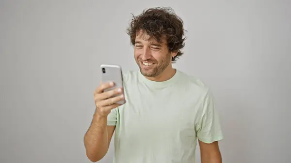 Junger Hispanischer Mann Lächelt Selbstbewusst Mit Smartphone Vor Isoliertem Weißen — Stockfoto