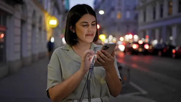 年轻美丽的惊慌失措的女人晚上在街上用智能手机 — 图库照片
