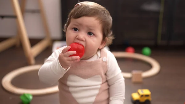 Adorable Toddler Sucking Plastic Ball Sitting Floor Kindergarten — Zdjęcie stockowe