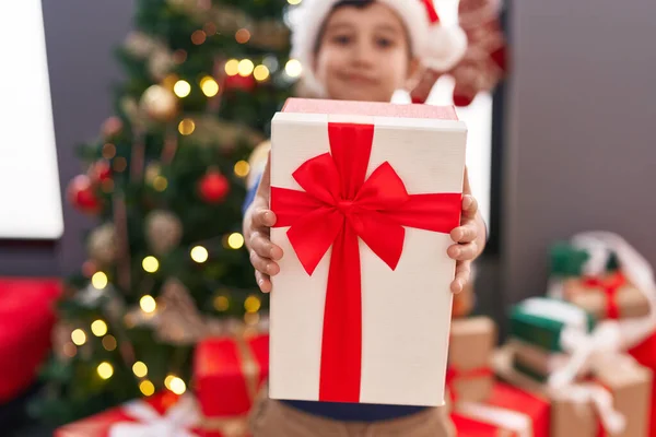 Adorable Hispanic Boy Holding Christmas Gift Standing Home — Stock Photo, Image