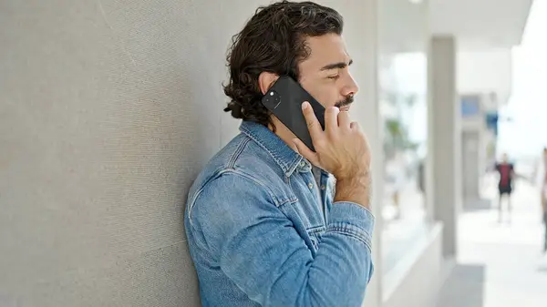 Young Hispanic Man Talking Smartphone Serious Expression Street — Foto de Stock