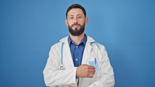 Young Hispanic Man Doctor Smiling Confident Standing Arms Crossed Gesture — ストック動画