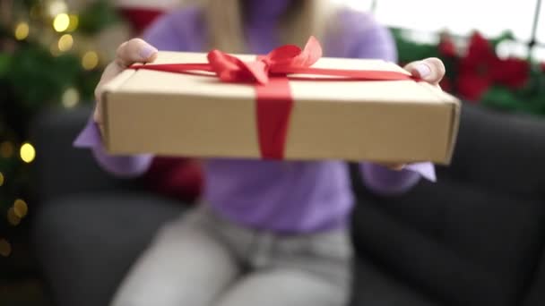 Young Blonde Woman Holding Gift Sitting Sofa Christmas Tree Home — Stock video