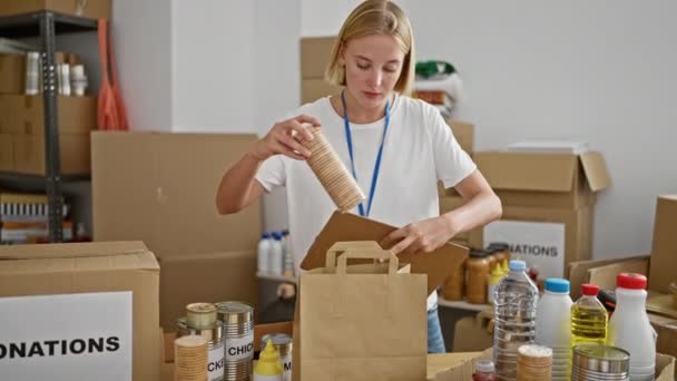 Young Blonde Woman Volunteer Reading Document Checking Products Charity Center — Stock Video