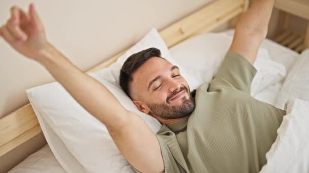 Young Hispanic Man Waking Stretching Arms Bedroom — Stock videók