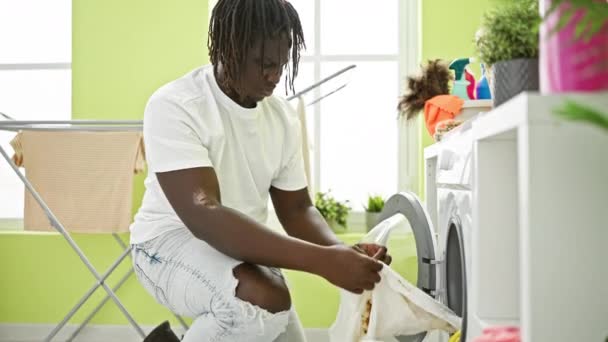 African American Man Washing Clothes Holding Dirty Shirt Laundry Room — Stock Video
