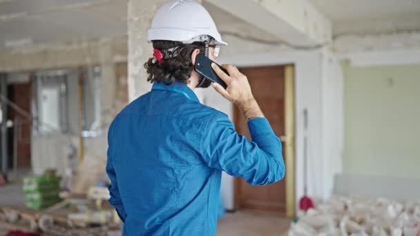 Young Hispanic Man Architect Standing Backwards Talking Smartphone Construction Site — Stock Video