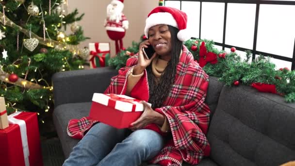 Mujer Africana Hablando Por Teléfono Sosteniendo Regalo Navidad Casa — Vídeos de Stock