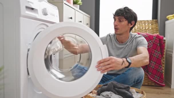 Young Hispanic Man Washing Clothes Holding Dirty Shirt Laundry Room — Stock Video