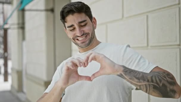 Young Hispanic Man Smiling Confident Doing Heart Gesture Hands Street — Vídeo de Stock