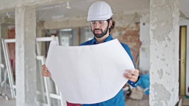 Young Hispanic Man Architect Holding Blueprints Looking Construction Site — Stock Video