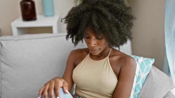 African American Woman Sitting Sofa Serious Expression Home — Vídeo de Stock