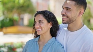 Man and woman couple smiling confident standing together at park