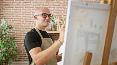 Young hispanic man artist smiling confident drawing at art studio