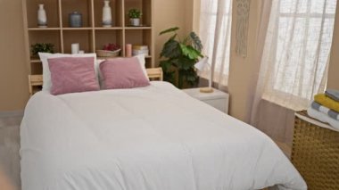 Genç sarışın kadın yatak odasında yüksek topuklu ayakkabılarını çıkarmaktan yorgun yatıyor.