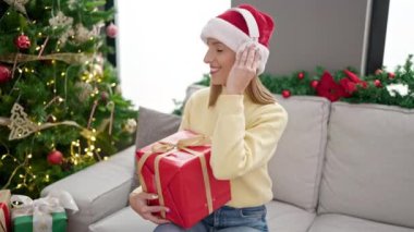 Genç sarışın kadın Noel ağacının yanında.