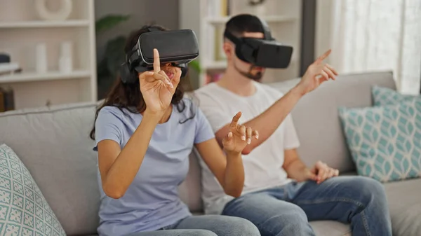 Beautiful couple immersed in love & gaming, using video game gadget for 3d vr experience at home