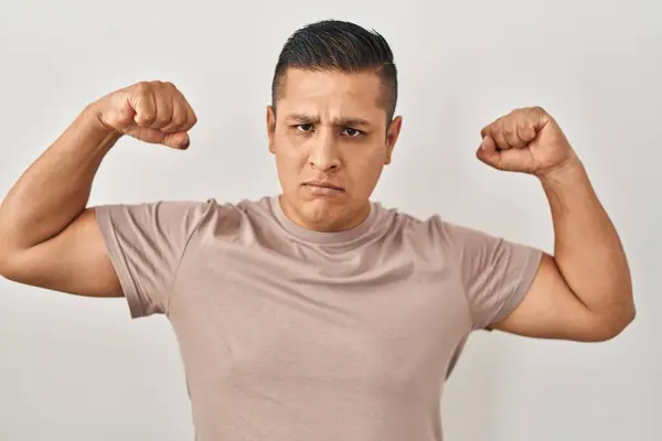 Hispanic Young Man Standing White Background Showing Arms Muscles Smiling — Stock Photo, Image