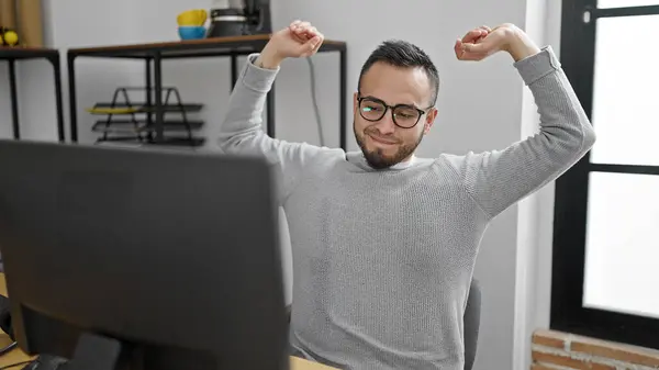Hispanic man business worker stretching at office
