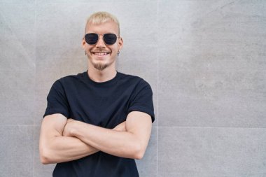 Young caucasian man smiling confident standing with arms crossed gesture over isolated white background