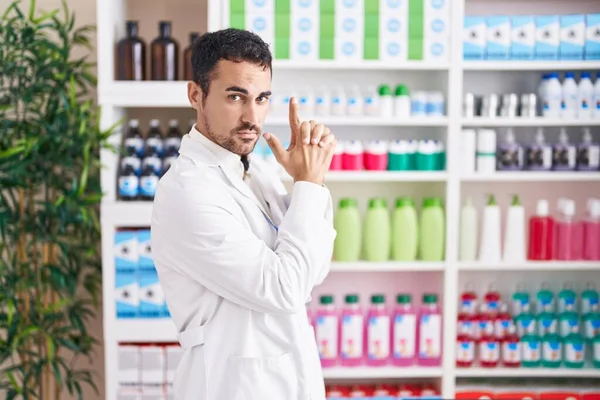 Handsome Hispanic Man Working Pharmacy Drugstore Holding Symbolic Gun Hand — Stock Photo, Image