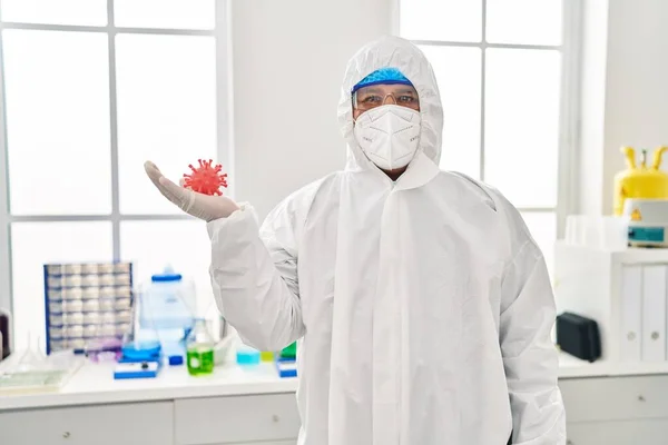 Hispanic Young Man Working Scientist Laboratory Holding Virus Toy Looking — Stock Photo, Image