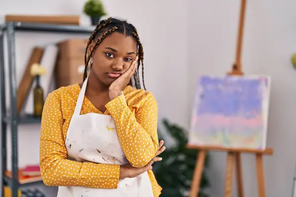 African american woman with braids at art studio thinking looking tired and bored with depression problems with crossed arms.