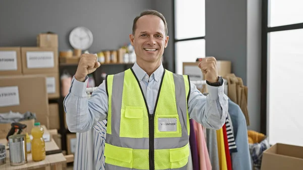 Smiling, confident middle-age man celebrates his own win as a charity volunteer at community center