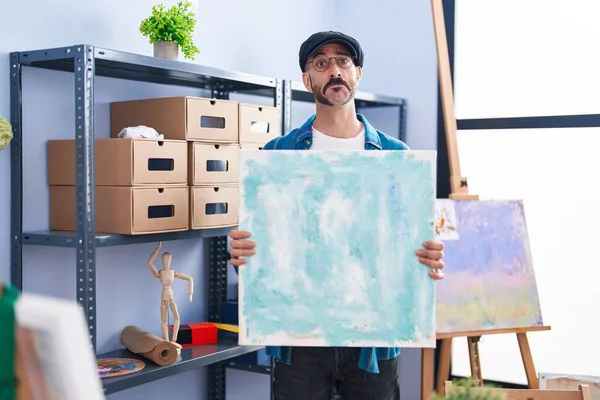 Hispanic Man Beard Holding Canvas Studio Depressed Worry Distress Crying — Stock Photo, Image