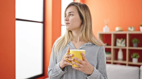 Young Blonde Woman Drinking Coffee Standing Home —  Fotos de Stock