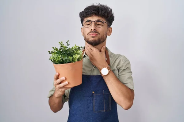 Arab Man Beard Holding Green Plant Pot Touching Painful Neck — Stock Photo, Image