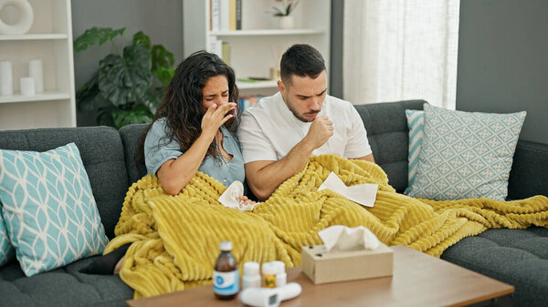 Man and woman couple being sick sneezing at home