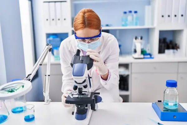 Young Caucasian Woman Scientist Wearing Medical Mask Using Microscope Laboratory — Stock Photo, Image
