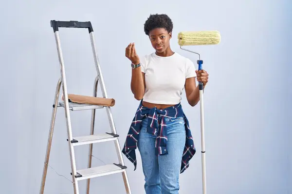 African American Woman Holding Roller Painter Doing Italian Gesture Hand — Stock Photo, Image