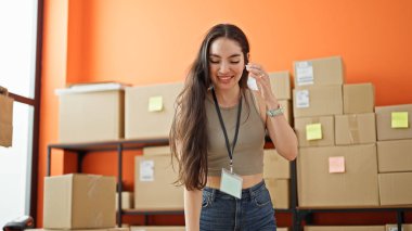 Genç, güzel, İspanyol bir kadın. İş adamı. Ofiste kendine güvenen bir şekilde gülümsüyor.