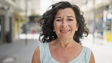 mature woman smiling in the city