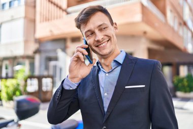 Young man business worker smiling confident talking on smartphone at street