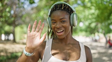 African american woman smiling confident having video call at park
