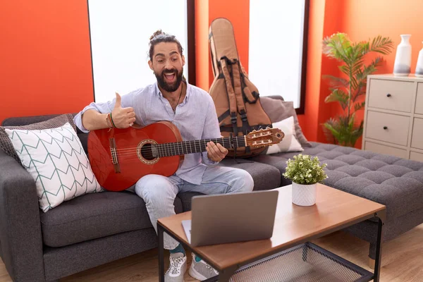 Hispanic Man Beard Playing Classic Guitar Home Pointing Thumb Side — Stock Photo, Image