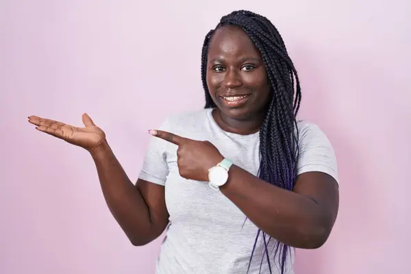 Jonge Afrikaanse Vrouw Staat Roze Achtergrond Verbaasd Glimlachend Naar Camera — Stockfoto