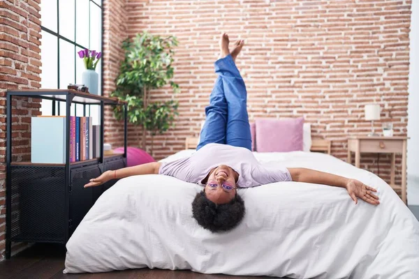 African American Woman Smiling Confident Lying Bed Legs Raised Bedroom — Stock Photo, Image