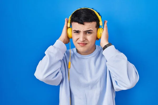 Non Binary Person Listening Music Using Headphones Covering Ears Fingers — Stock Photo, Image