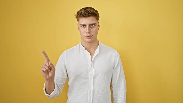Young Caucasian Man Saying Finger Serious Face Isolated Yellow Background — Stock Photo, Image