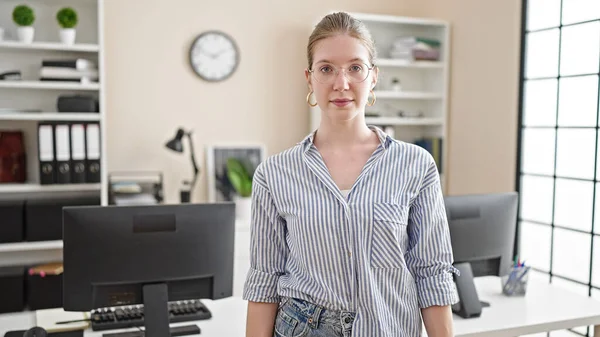 Young blonde woman business worker with serious face at office