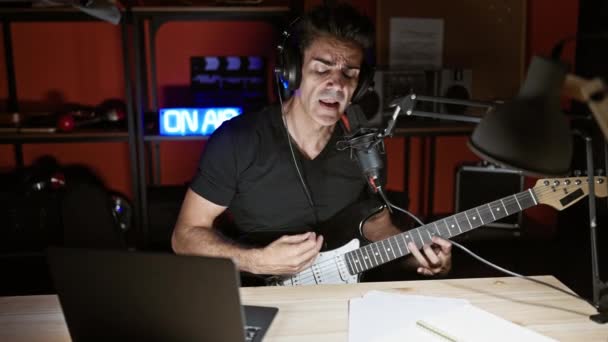 Young Hispanic Man Musician Singing Song Playing Electrical Guitar Radio — Stock Video
