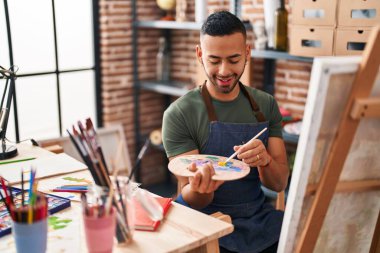 African american man artist smiling confident drawing at art studio