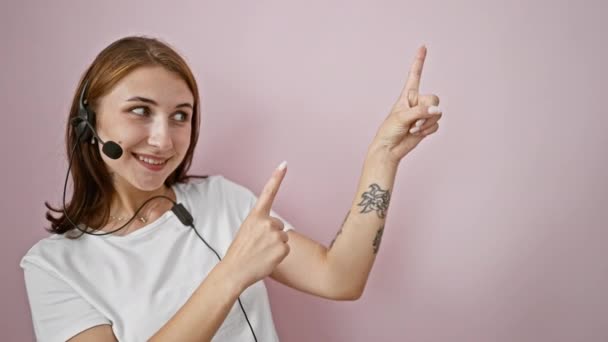 Young Woman Call Center Agent Pointing Side Isolated Pink Background — Stock Video
