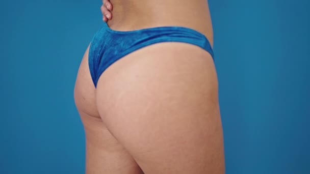 Young Chinese Woman Wearing Bikini Massaging Ass Isolated Blue Background — Wideo stockowe